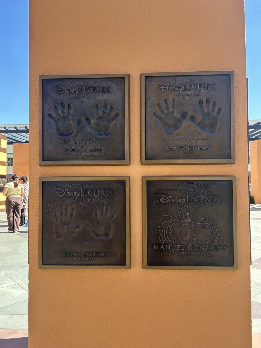Bronze Disney Legends handprint plaques on a column