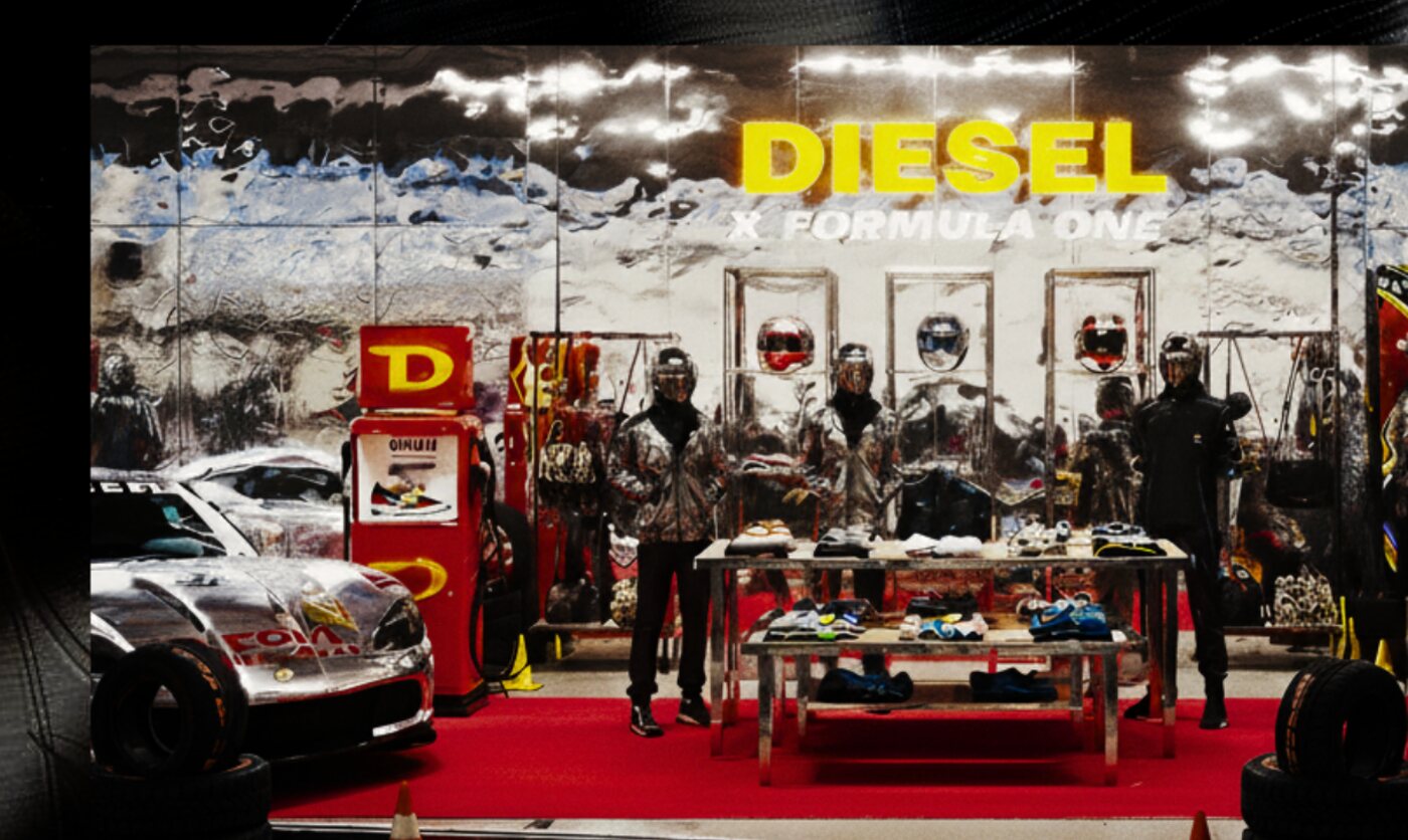 Pop-up concept with chrome walls, a yellow Diesel sign, helmet display cases, a red carpet and race cars on either side