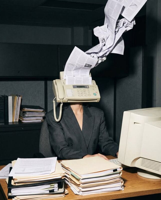 Inspiration: person in a grey suit with a fax machine for a head spewing paper at a cluttered desk
