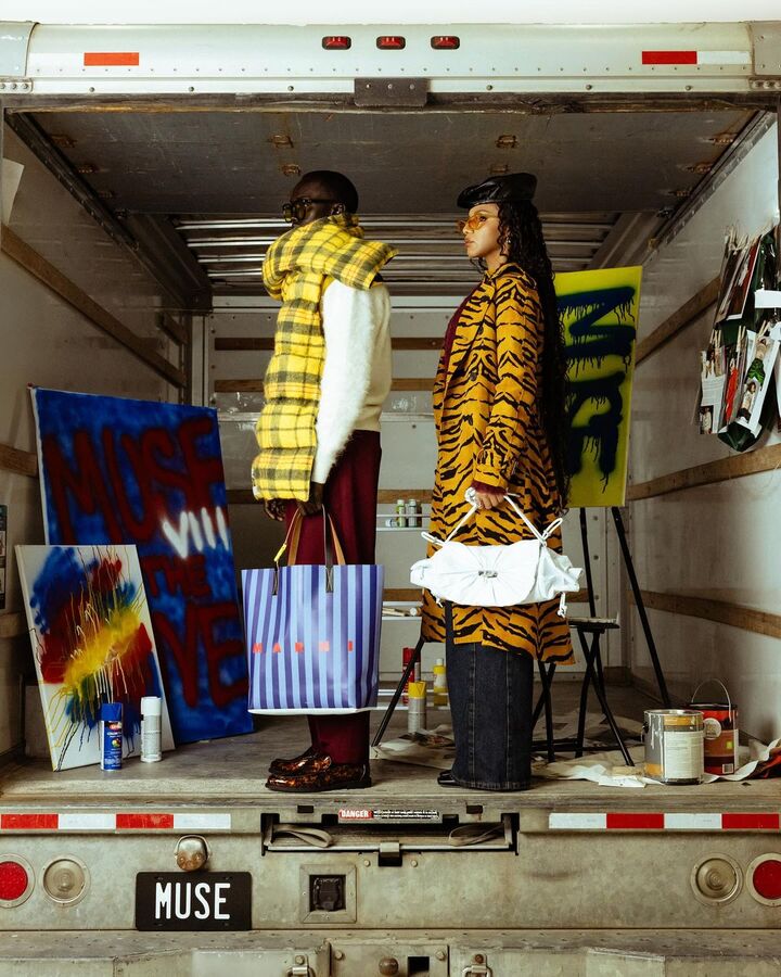 Inspiration: two models in yellow plaid and tiger print inside a truck full of spray-painted canvases
