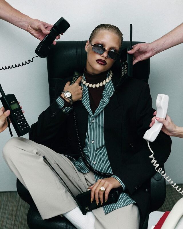 Inspiration: model in a desk chair surrounded by hands holding out phones
