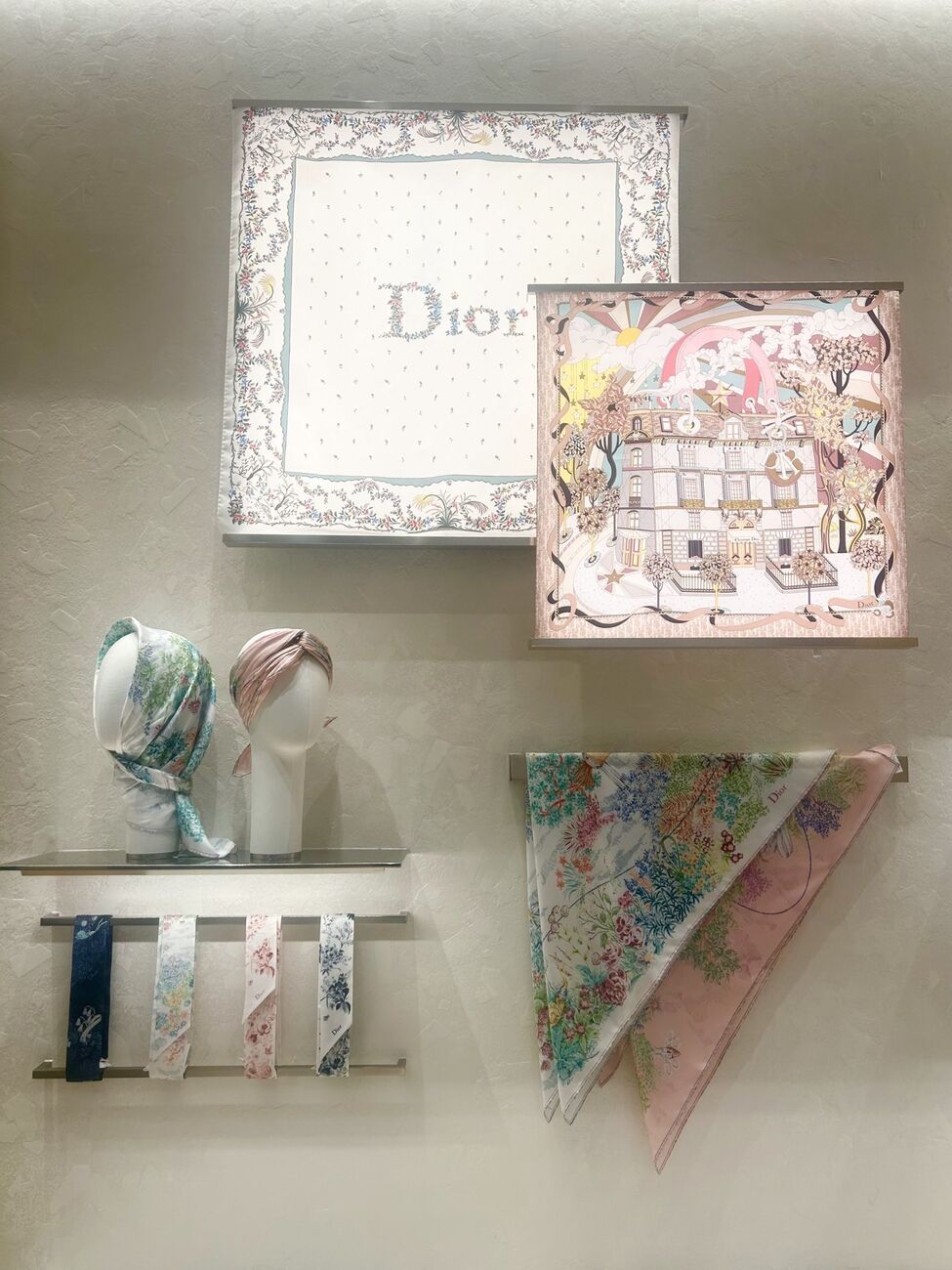 Dior scarves and twillies displayed with mannequin heads