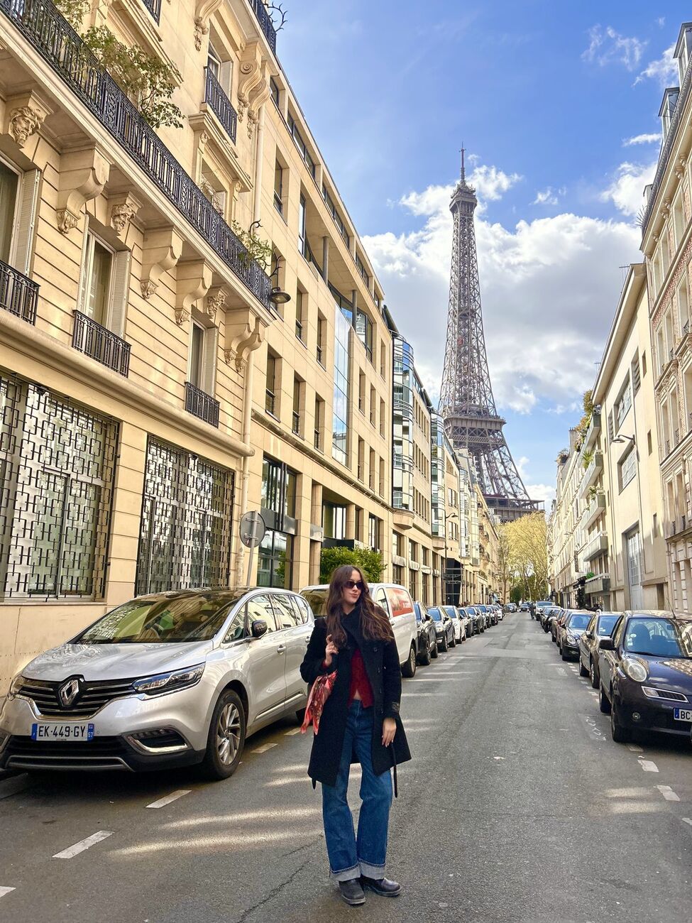 Angelina in a long coat and wide-leg jeans on a Paris street with the Eiffel Tower behind