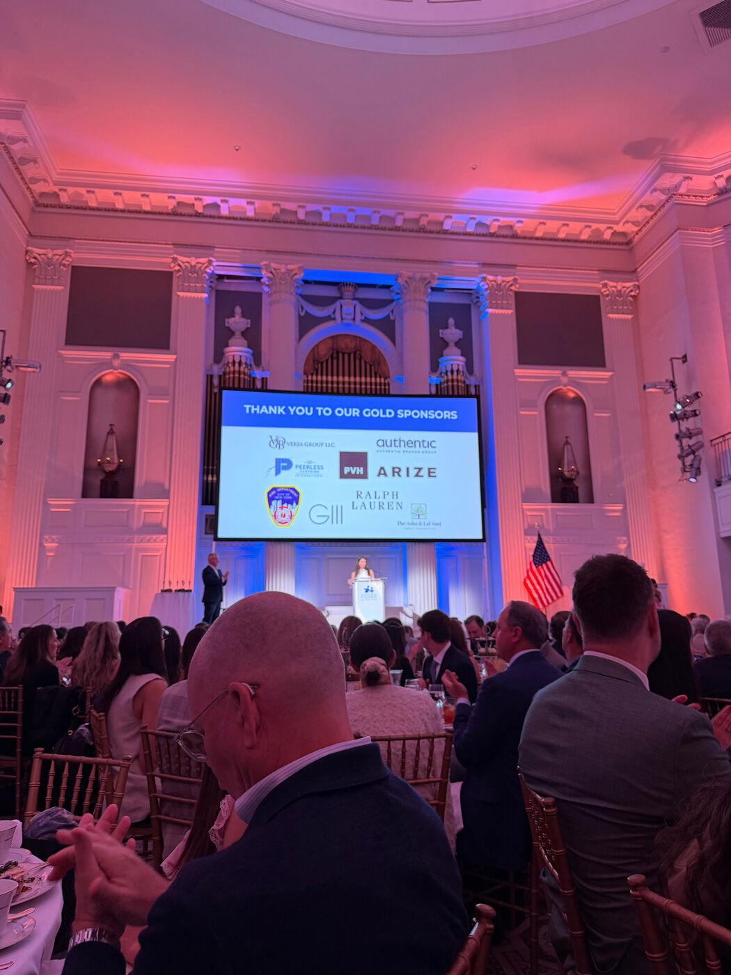 Gala stage with a presentation screen and pink lighting