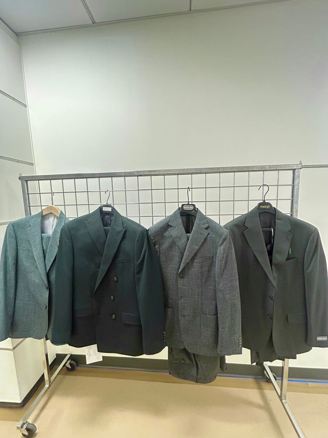 Rack of suit jackets merchandised by color
