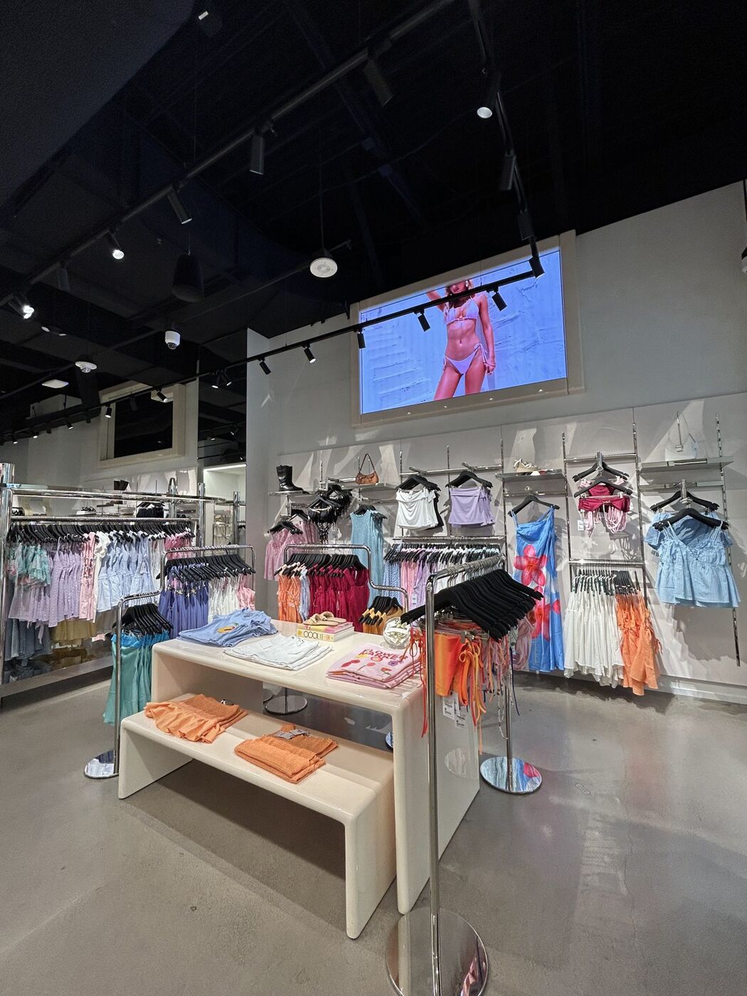 Store floor with color-blocked racks and a nesting table display